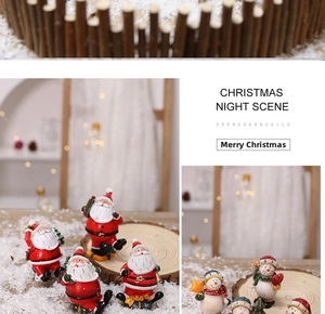 Detailed Christmas miniature night scene with Santa and snowman figures in snowy display