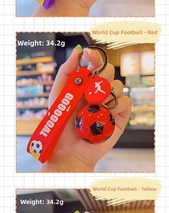 Close-up of a red football keychain with GOOOOOAL strap, weighing 34.2g for bags