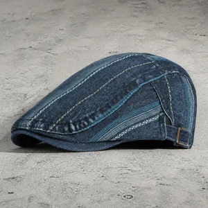 Vintage dark blue washed denim flat cap with adjustable metal buckle and contrast stitching