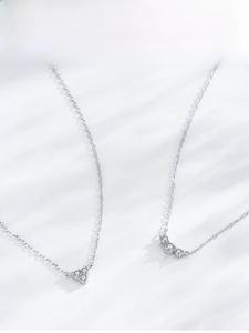 Close-up of geometric S925 sterling silver necklaces with sparkling zircon pendants