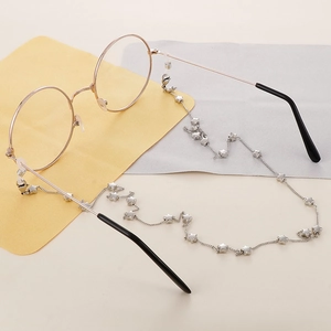 Titanium steel glasses chain with silver stars on yellow and grey velvet background
