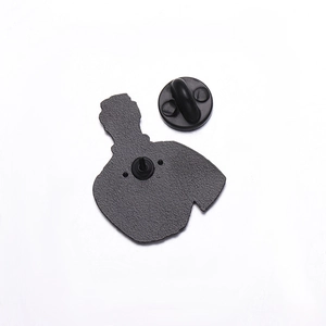 Macro view of metal lapel pin back with black rubber butterfly clutch and pin detail
