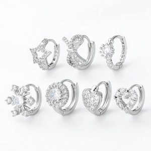 Set of 7 silver zircon hoop earrings featuring star, heart, crown, and snowflake designs