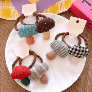 Detail view of colorful mushroom hair ties with polka dots and checks on a paper card