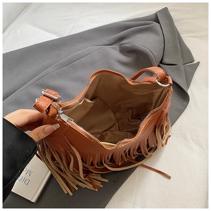 Detailed view of the brown lychee pattern crossbody bag with long bohemian tassels