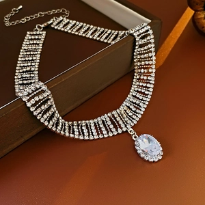 Macro view of water-drop zircon pendant and rhinestone necklace on a jewelry box