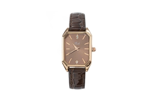 Close-up of octagonal rose gold watch case with brown crocodile leather strap and dial
