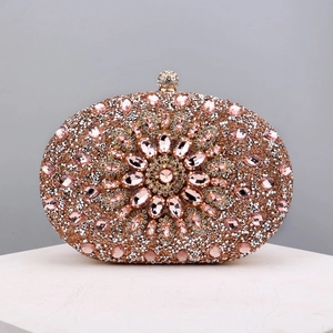 Macro detail of pink rhinestone evening bag with sparkling floral gemstone pattern