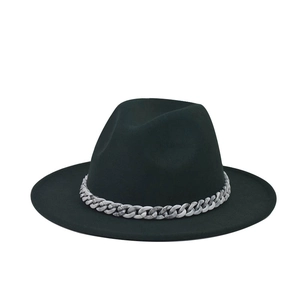 Detail of black wide brim fedora hat with a stylish grey marble textured chunky chain