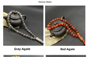 Detail of grey and red agate prayer beads with tassels and decorative charms