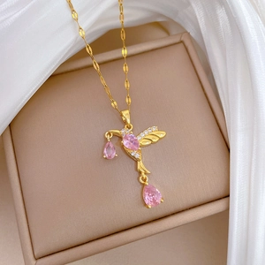 Detail of golden hummingbird necklace with pink pear-shaped gems and micro-set diamonds