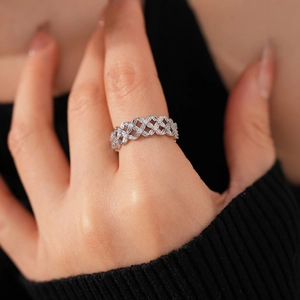 Close-up of hollow flower ring in silver finish with pavé set cubic zirconia