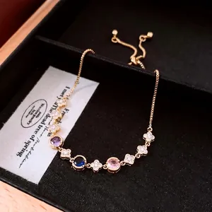 Adjustable 18k gold plated bracelet with clover links and colorful gemstones
