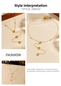 Detail view of gold-plated Y-necklace with diamond-set hollow flower pendants on thin chain