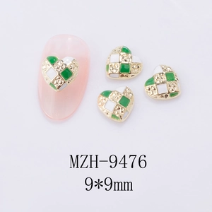 Macro shot of green and white checkerboard heart nail charms with gold alloy frame