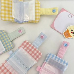 Detailed view of mini checkered fabric photo albums with transparent PVC card inserts