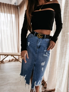 Close-up of distressed dark blue denim midi skirt with front slit and frayed hem details