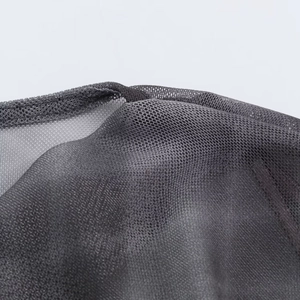 Macro detail showing the dark grey mesh fabric texture and woven fiber structure