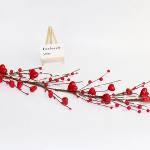Close-up of red heart berry vine decoration with white berries for Valentine's Day