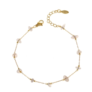 Detail of stainless steel gold chain bracelet with irregular white stone and lobster clasp