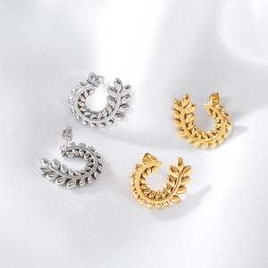Elegant wheat leaf C-shape stud earrings in gold and silver finish on white silk