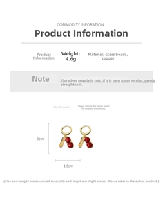 Detail view of peanut-shaped earrings with gold plating and red glass bead accents