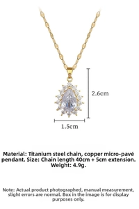 Macro detail of teardrop water drop pendant with micro-pave crystals on gold titanium chain