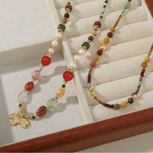 Ethnic beaded necklace with natural turquoise, pearls and golden pony pendant