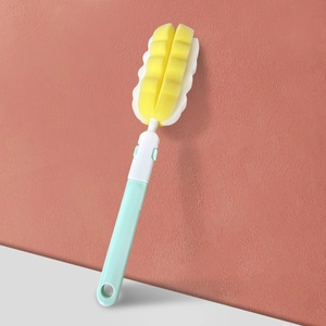 Detail of long-handle sponge bottle brush with mint green handle and wavy cleaning head