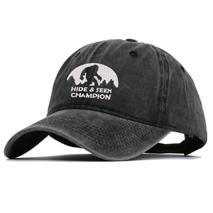 Detailed close-up of embroidered Bigfoot silhouette and Hide Seek Champion text on cotton cap