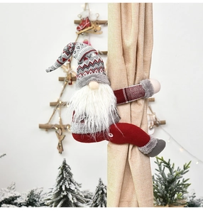 Detail of Christmas forest gnome curtain buckle with red knitted hat and plush white beard