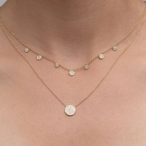 Close-up of layered 18K gold plated zircon necklaces on a model showing elegant drape