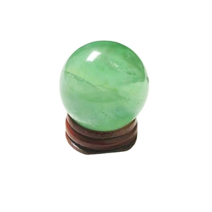 Polished natural green fluorite crystal sphere on a wooden stand for home office decor