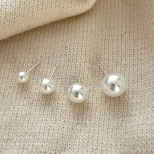925 Sterling Silver Pearl Studs in four sizes displayed on beige knit fabric background