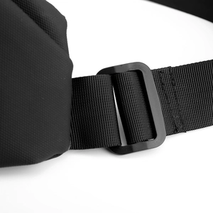 Detail of adjustable nylon strap and matte buckle on waterproof sling bag with honeycomb texture