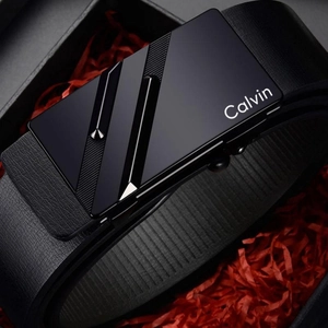 Close-up of black leather belt with matte automatic buckle in premium gift box