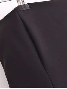 Macro detail of black plain weave fabric texture on a hanger for midi dresses