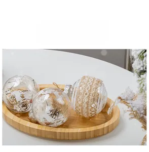 Close-up of three 8cm Christmas ornaments with lace and reindeers on a wooden tray