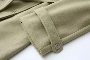 Detailed close-up of wool jacket cuff showing premium texture and button strap