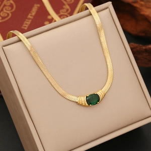 Golden herringbone chain necklace featuring a vintage oval emerald green stone pendant