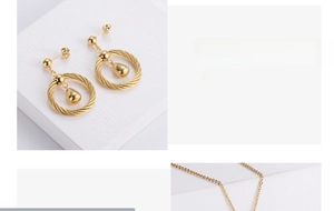 Detailed close-up of gold-plated woven drop earrings and necklace jewelry set pieces