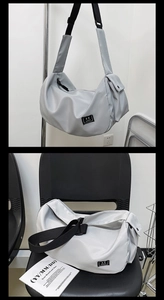 Close-up of light gray nylon crescent bag featuring side pocket and adjustable black strap