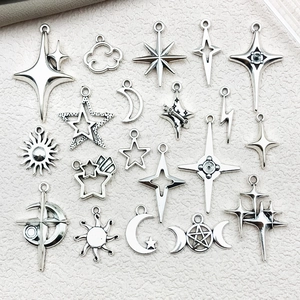 Detailed view of silver celestial alloy charms featuring stars, moons and sun designs
