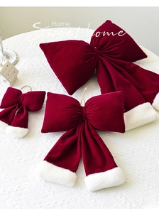 Detail of red velvet Christmas bows with white faux fur edges for holiday decoration