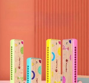 Vertical view of four colorful 16-hole wooden harmonicas with cute cartoon illustrations