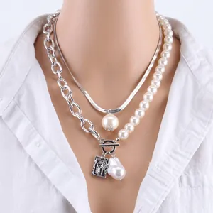 Detail of silver double-layered snake chain with baroque pearl and portrait medallion