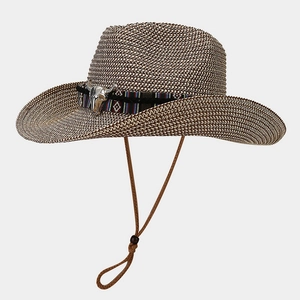 Close-up of woven straw cowboy hat with ethnic band, bull skull metal buckle and chin cord