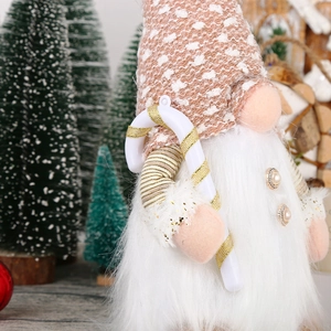 Plush Christmas gnome with white beard, pink knit hat, and candy cane decoration