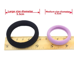 Size comparison of 4.5cm and 5.5cm elastic hair ties with ruler for scale