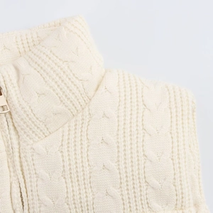Close-up of knit texture and metal zipper on this cream sleeveless vest